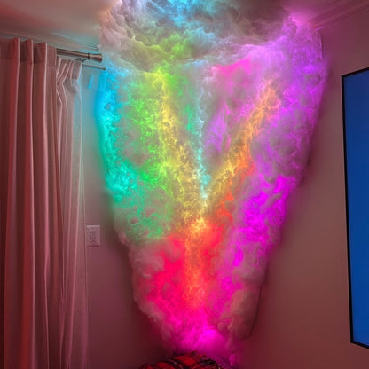 Colorful cloud-shaped light fixture on a wall in a room with a bed and TV.